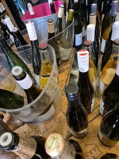 Open and closed wines on a wooden table made from wine boxes.